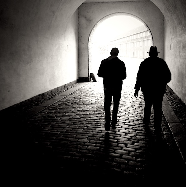 two men walking through tunnel